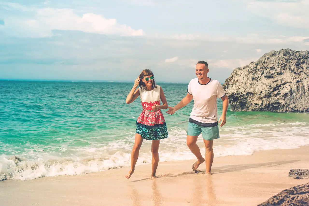 A couple walking together along a tropical beach in Bali